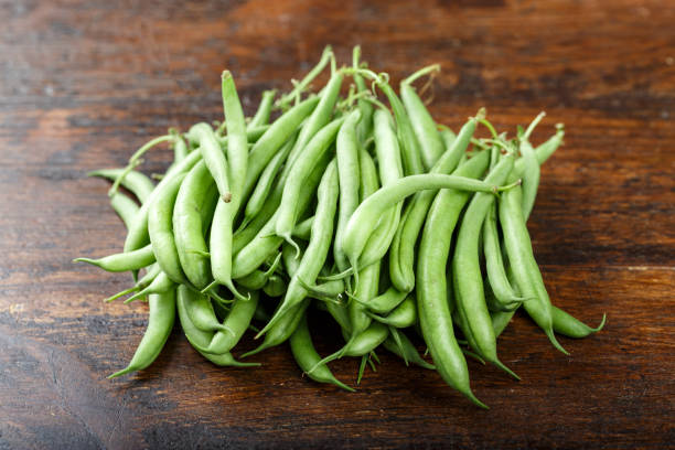 istock fresh green beans on a wooden background. 1139458963
