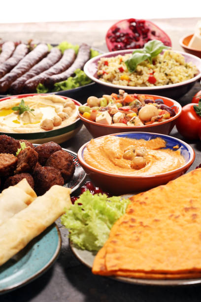 istock Middle eastern or arabic dishes and assorted meze, concrete rustic background. Falafel. Turkish Dessert Baklava with pistachio. Halal food. Lebanese cuisine 1139459593