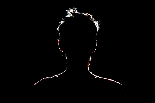 silhouette of man in dark place, anonymous backlit contour a