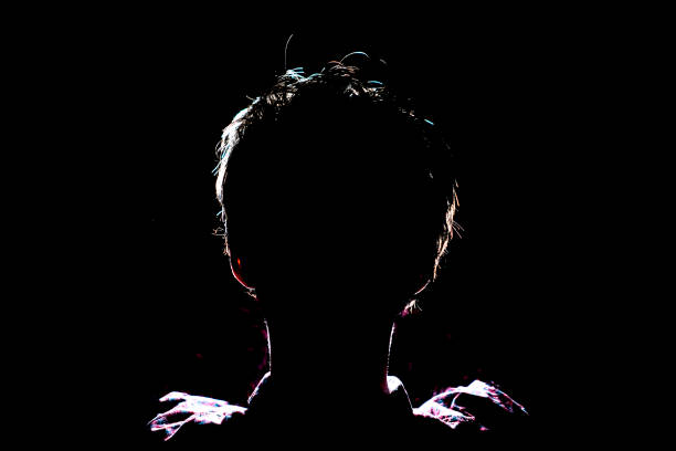 istock silhouette of man in dark place, anonymous backlit contour a 1139459626
