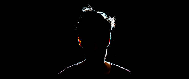 istock silhouette of man in dark place, anonymous backlit contour a 1139459628