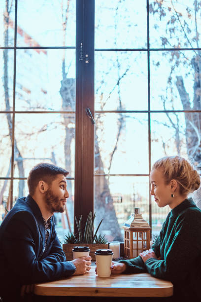 istock Romantic couple in the cafe is drinking coffee and talking. 1139460513