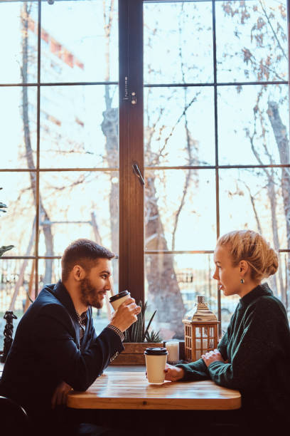 istock Romantic couple in the cafe is drinking coffee and talking. 1139460626