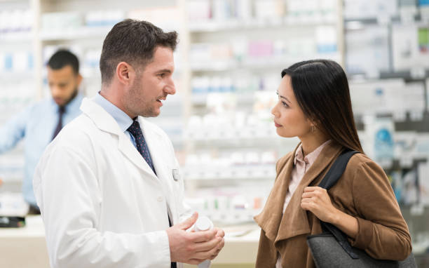 istock Young Asian Woman Consulting With Pharmacist 1139460963