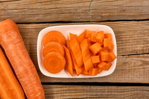 istock Carrots isolated on wood background 1139461067