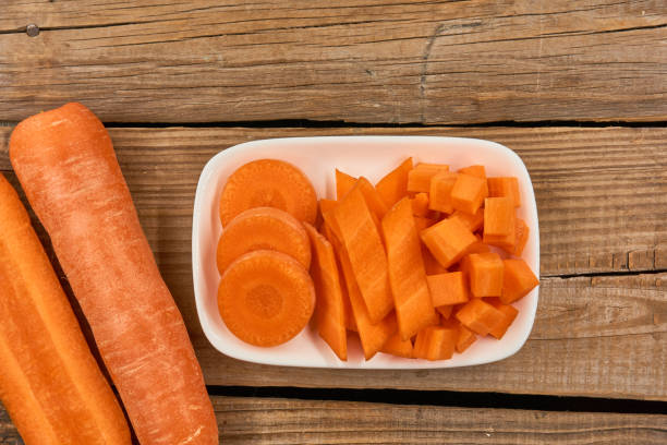 istock Carrots isolated on wood background 1139461722