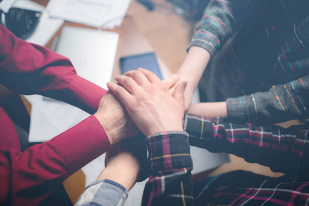 istock team of friendly workers giving high five in the office occupation 1139461742