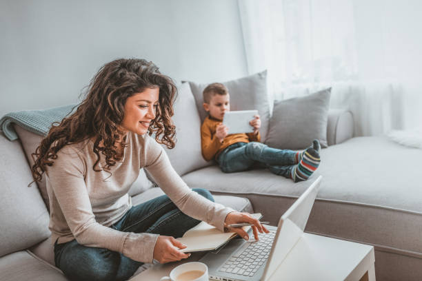 istock Busy young woman with son in home office 1139461896