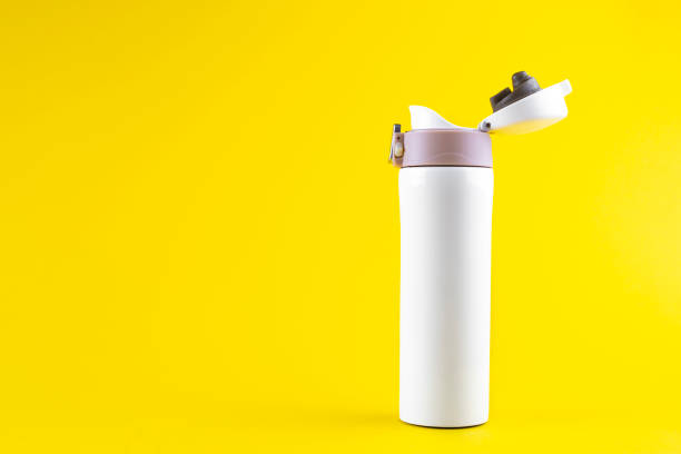 istock white thermos for walking on a bright yellow background. 1139462300