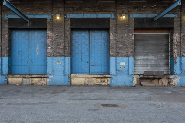 istock Blue doors with lights on the back of a vintage abandoned warehouse 1139466726