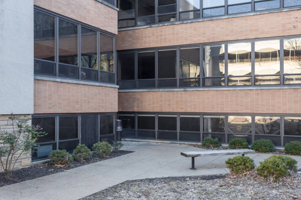 istock Two generic office buildings meet at corner in faceless urban area 1139466865