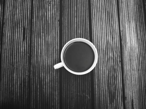 istock Black coffee cup on wood background 1139467800