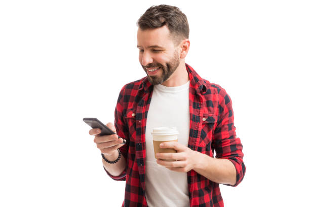 istock Man Holding Drink And Connecting With World 1139470262