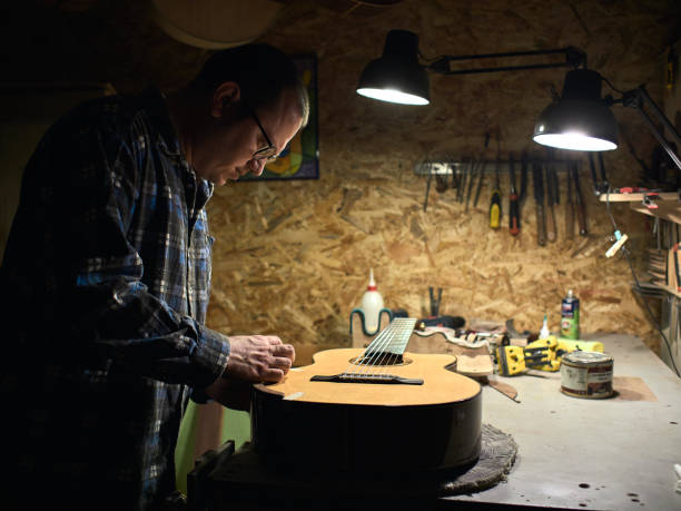 istock In the guitar workshop, Guitars Luthiers sets up a stand under the arm. 1139471308