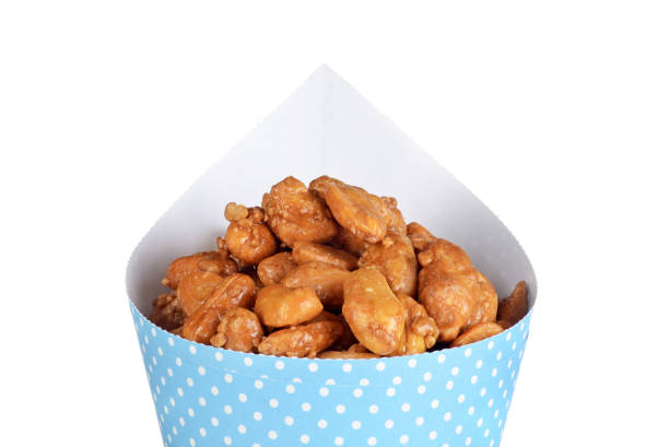 istock isolated closeup honey covered peanuts in a blue cone 1139472553