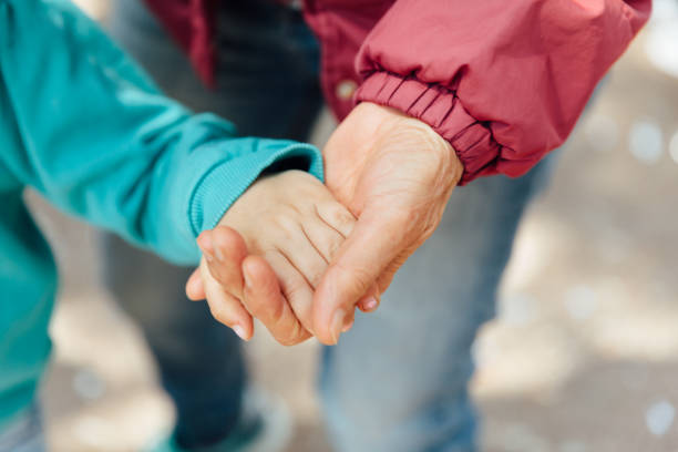 istock Holding hands senior woman with child 1139474308