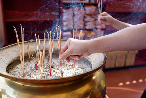 Image of Burning incense sticks in Incense holder Pot at temple Bangkok City, Thailand.