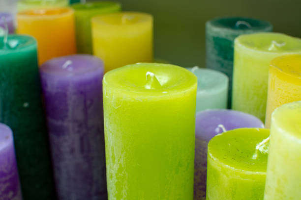 Many colorful unlit candles close up, decorative background