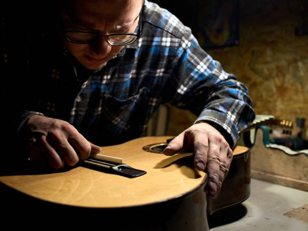 istock In the guitar workshop, Guitars Luthiers installs a saddle. 1139476216