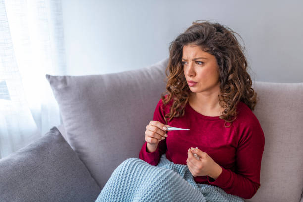istock Young woman is looking at the thermometer. 1139476890