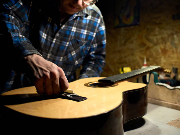 istock In the guitar workshop, Guitars Luthiers installs a saddle. 1139476958