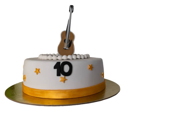 istock cake decorated with number ten and guitar on white background 1139477464