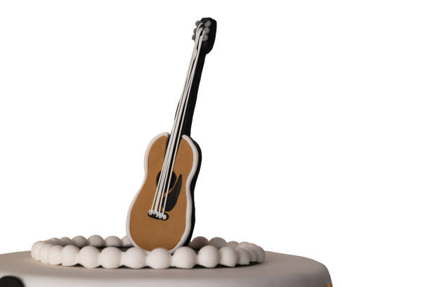 istock cake decorated with guitar on white background close-up 1139477479