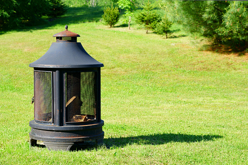 A secure backyard fireplace ready to light.