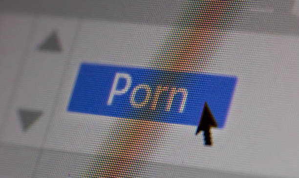 Porn text on computer screen. Closeup screenshot, screen pixels and cursor pointer Porn text and sex content concept on computer screen. Closeup screenshot, screen pixels and cursor pointer sleaze stock pictures, royalty-free photos & images