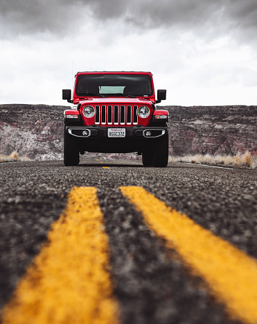 Page, Arizona, United States - March 6, 2019: Photo of a Jeep Wrangler Sahara 2019 edition parked in the centre of the road in Page, Arizona on a cloudy day. It is the new wild offroad vehicle by Jeep.
