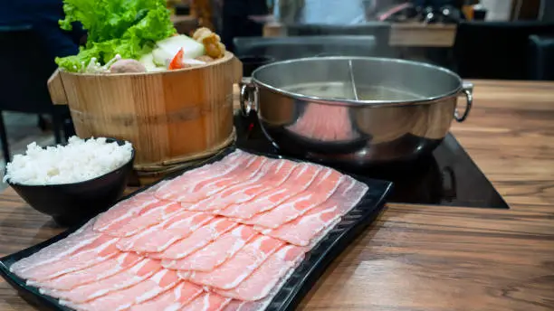 Pork slice, rice and variety vegetable for sukiyaki or hotpot set in the restaurant with selective focus (Taiwan food)