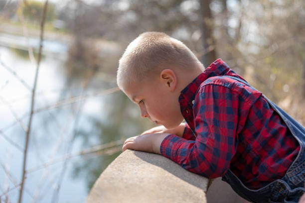 A boy looking at the road in the garden