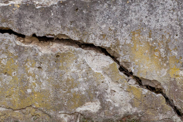 istock Cracked White Wall Texture Background, very old wall with a crack on it 1139491093