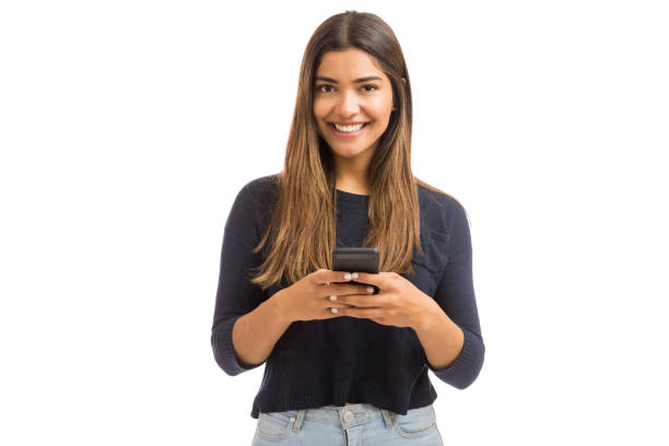 istock Brunette Woman Smiling While Holding Phone 1139495240