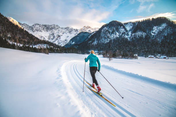 Cross-country skiier gliding on the slopes stock photo