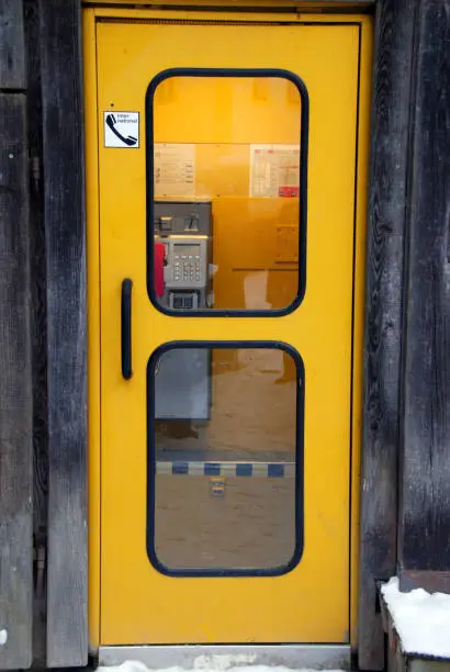 old yellow german public telephone