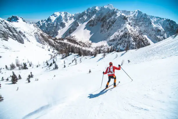 Men ski touring in the mountains on snow, exploring the Dolomite.