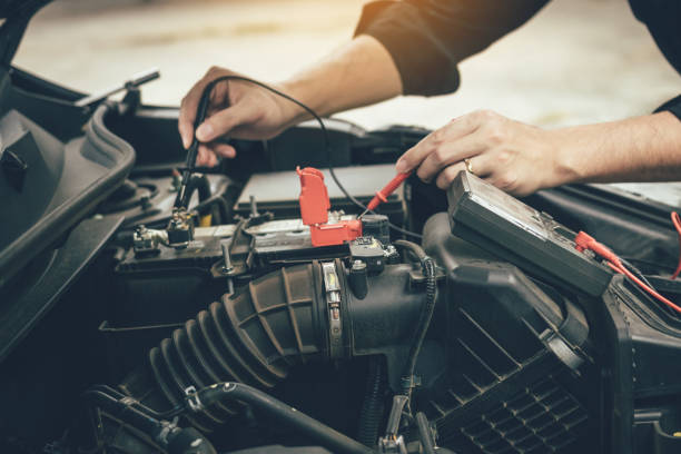 istock Car mechanic is using the car battery meter to measure various values and analyze it. 1139500867