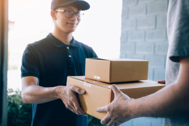 istock Smart courier making a delivery to a customer at home. 1139501052