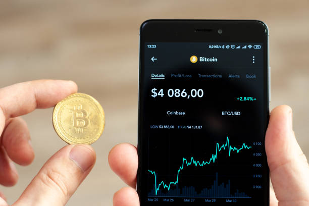 Hands holding a smartphone with bitcoin exchange rate stock photo