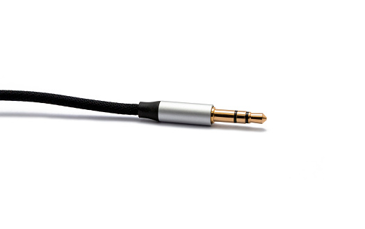 Black aux audio cable isolated on white background. File contains with clipping path.