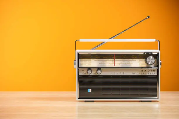 Transistor radio receiver on wood table in home interior. 3d render