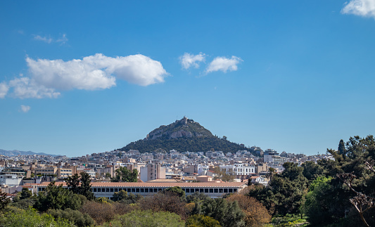 Greece, Athens city center. Attalus stoa and lycabettus hill on blue sky background,