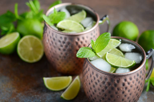 istock Moscow mule cocktail with ginger beer, vodka, lime and mint in a cooper mugs. 1139514309