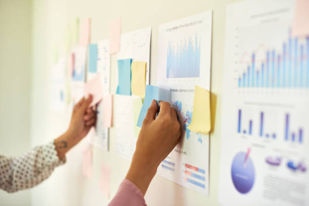 istock Business people discussing charts on wall 1139516055