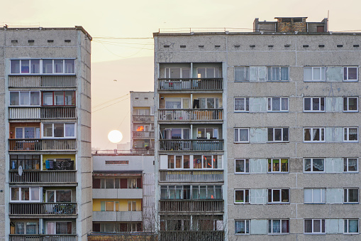 sunset between poor suburban block of flats apartment buildings in the city