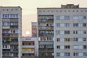 sunset between poor suburban apartment buildings in the city