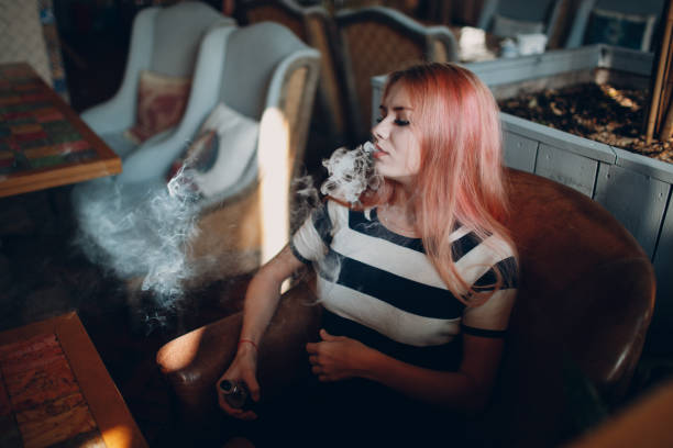 istock Young woman smoking electronic cigarette. Vape concept. 1139518491