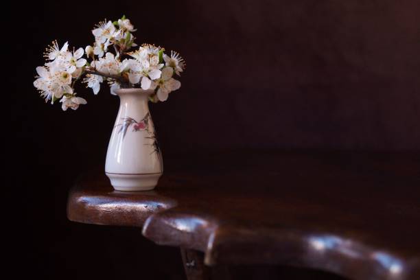 istock Vase with spring flowers on a wooden table 1139522359
