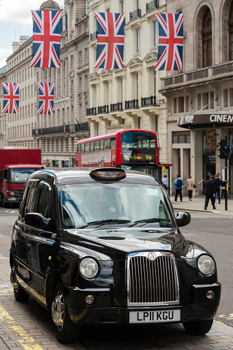 London, UK - Jun 24 2016: A black cab late in the day on Regent Street in Piccadilly Circus.